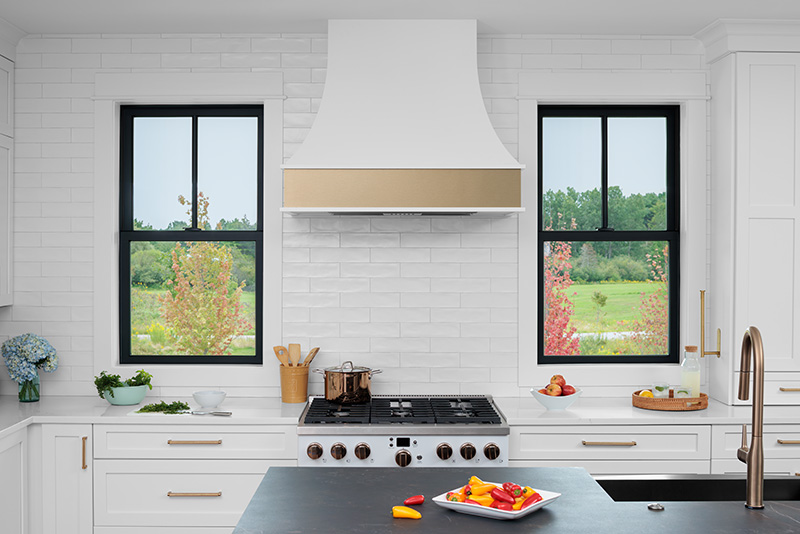 White modern kitchen with black windows. 