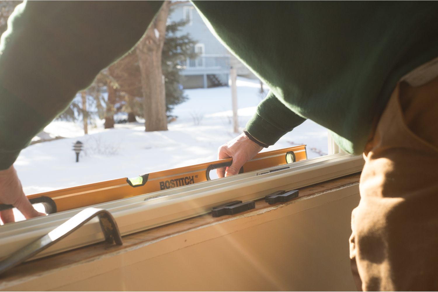 Renewal by Andersen Window replacement expert installer measuring a window 