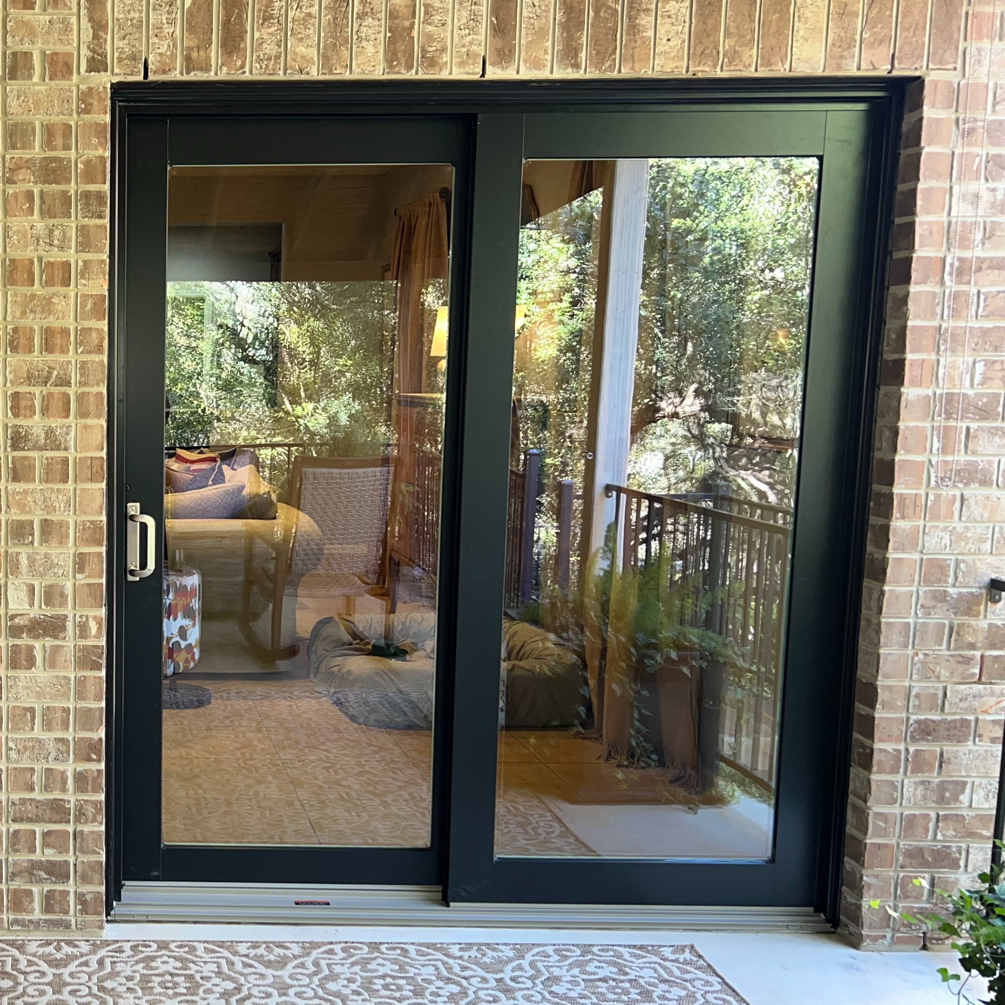 A series contemporary doors. These are black sliding glass doors and have brushed nickel hardware.