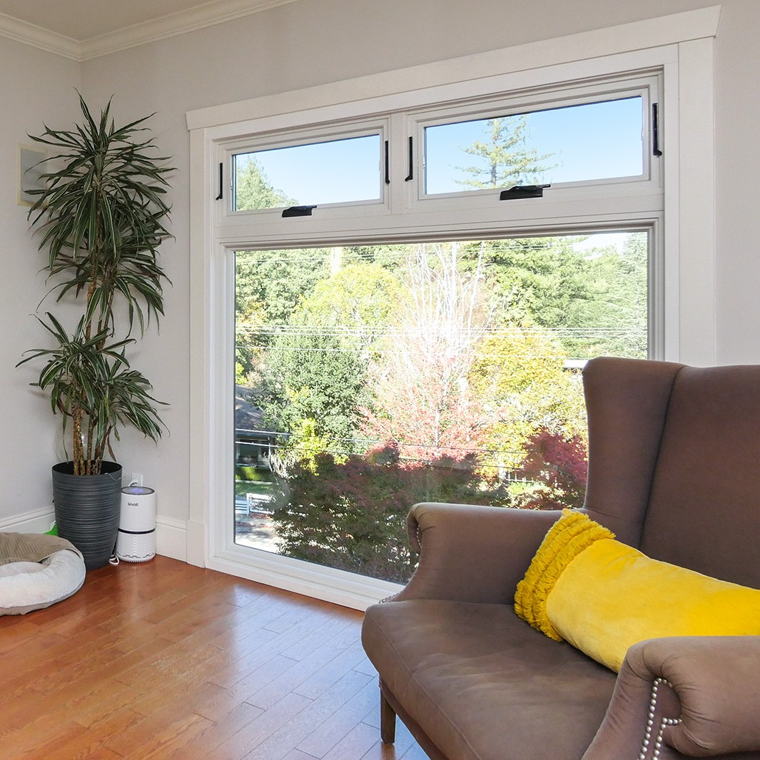 Two awning windows used as operable transoms above a large picture window.