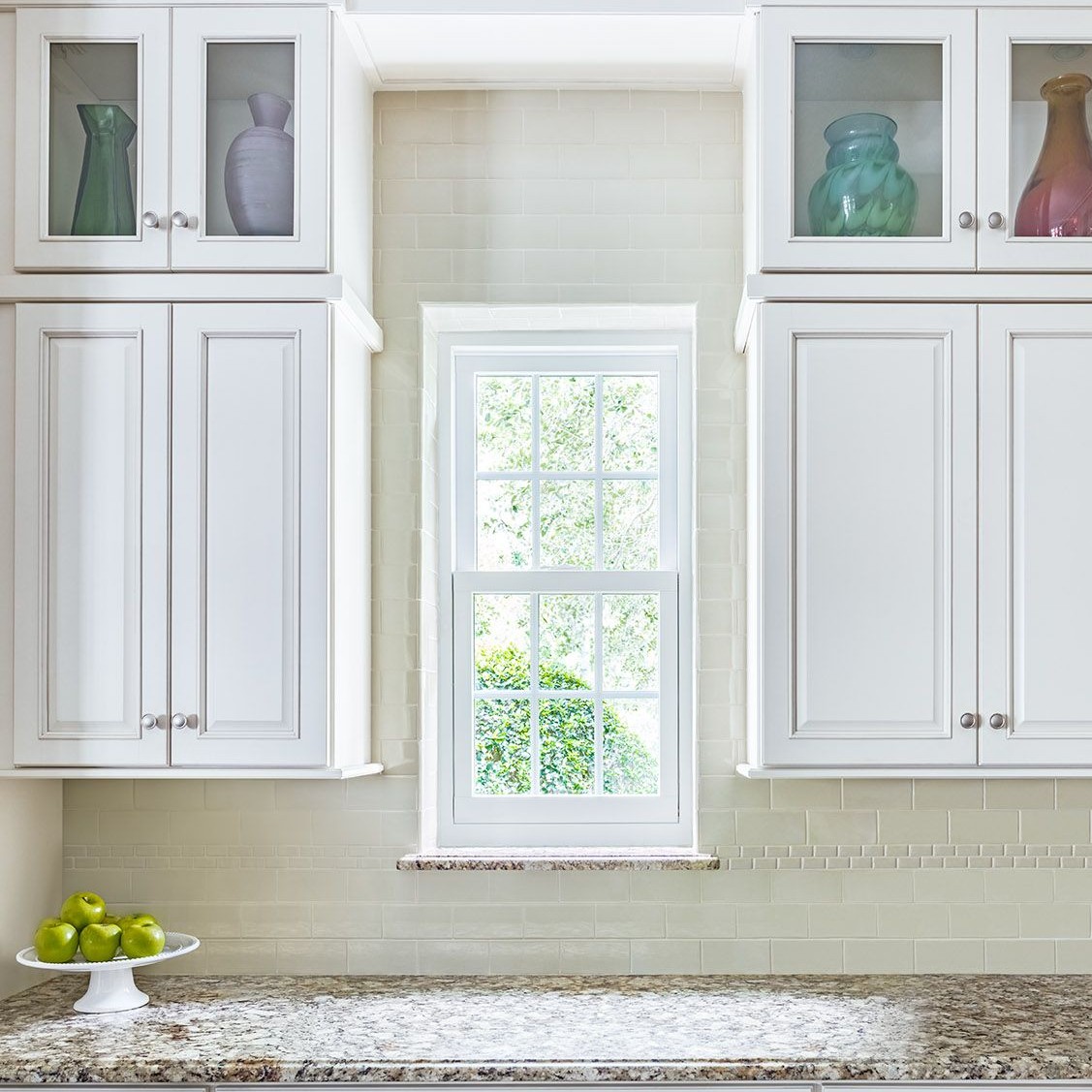 Double hung windows can be large or small. Even the tightest spaces can have a window, like this between cabinets.
