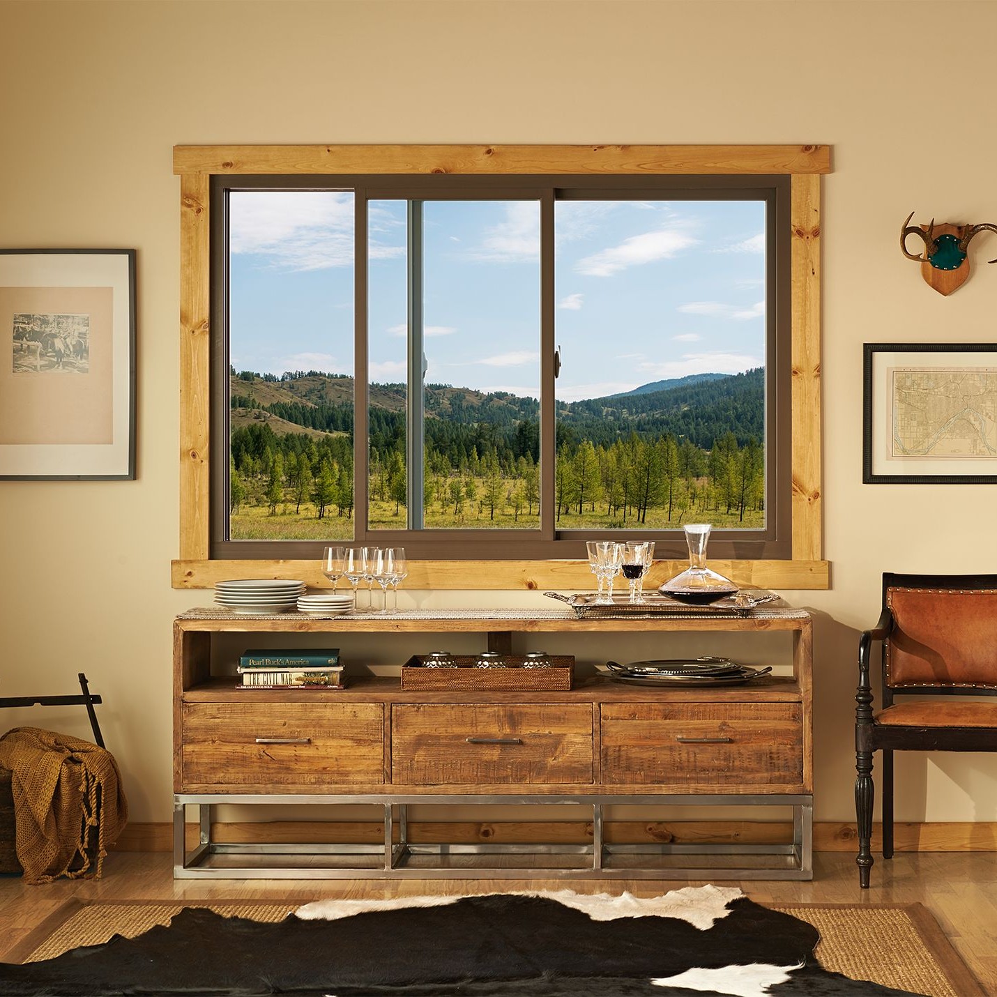 A buffet or side table in a dining room. The decor is rustic cowpoke. 