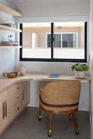 An office space in breegan Jane's home. The room has glider windows.